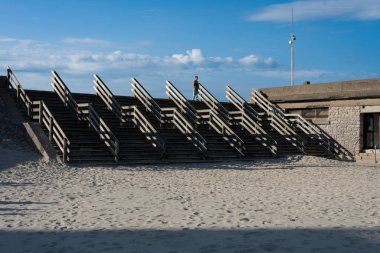 Berk-Sur-Mer, France - 09 21 2024:  View of the Berk esplanade with the jetty, the wooden staircase, the sea, the beach and the horizon clipart