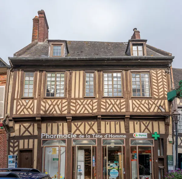 stock image Eu, France - 09 21 2024:  View the facade of a corbelled house with a projecting stone representing a head