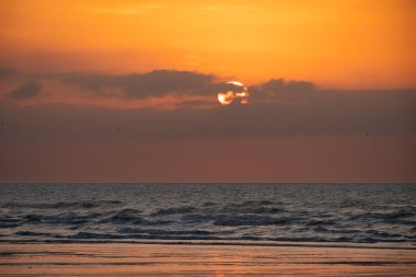 Sahilden deniz üzerinde gün batımı manzarası