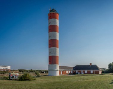 Berck, France - 09 19 2024:  Exterior view of the white and red Berck Lighthouse and the caretaker's house clipart