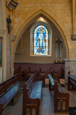 Berck, France - 09 20 2024:  View inside Saint John Church of a stained glass window and an aisle clipart