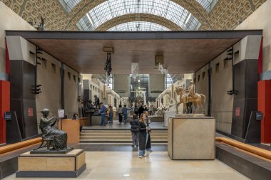 Paris, France - 11 01 2024: Orsay museum. View of statues in the main hall of the museum and the glass canopy background clipart