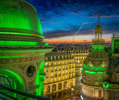 Paris, France - 11 23 2024: Boulevard Haussmann. Panoramic view of Paris, Eiffel Tower, golden dome of Le Printemps Haussmann roof terrace with green light at christmas clipart