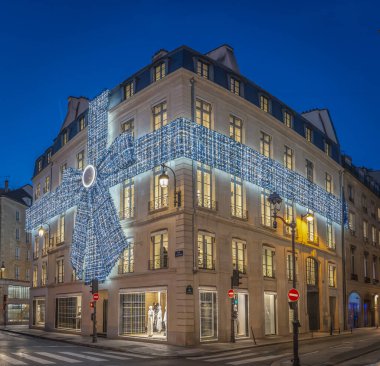 Paris, France - 11 26 2024: View of facade of Coco Chanel Paris with christmas decoration at night clipart