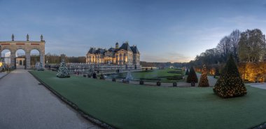 Maincy, France - 11 29 2024: Le Grand Noel. Panoramic view of the facade of Vaux-le-Vicomte Castle and the garden with Christmas lights clipart