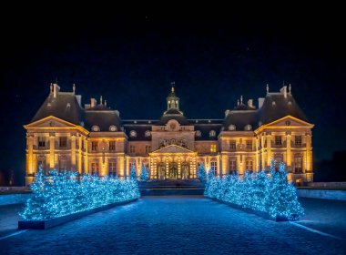 Maincy, France - 11 29 2024: Le Grand Noel. Panoramic view of the facade of Vaux-le-Vicomte Castle and the garden with Christmas lights clipart