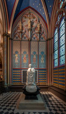 Paris, France - 12 16 2024: Notre Dame de Paris. View a statue and stained glass window inside a chapel of the Cathedral clipart