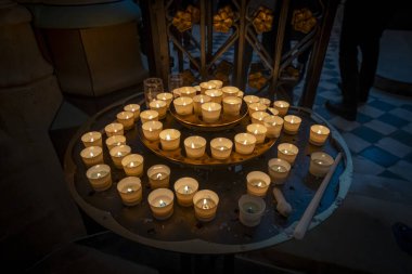 Paris, France - 12 16 2024: Notre Dame de Paris. View candles lit at the edge of the altar inside the Cathedral clipart