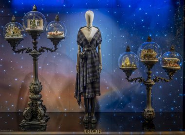 Paris, France - 12 11 2024: View Showcases of Christian Dior Paris with christmas decoration at night for Christmas clipart