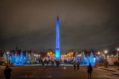 Paris, France - France - 12 18 2024: View Place de la Concorde with Obelisk and The Paris Christmas Market decoration by night clipart