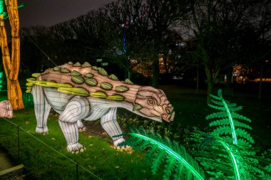 Paris, France - 12 12 2024: Discovering Jurassic species in the alleys of the Jardin des Plantes, which are being illuminated by Christmas night clipart