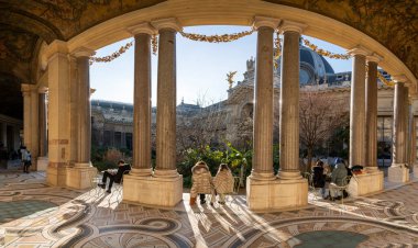 Paris, France - 12 26 2024: Le Petit Palais. View of people sitted in the semicircular peristyle of the courtyard, decorated with Tuscan-style columns and bas-reliefs clipart