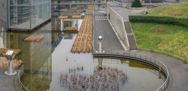 Paris, France - 01 12 2025: Villette Canal. Panoramic view of reflection of the park and the Science and Industry museum building behind clipart