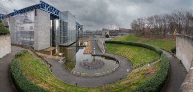 Paris, France - 01 12 2025: Villette Canal. Panoramic view of La Geode with reflection of the park and the Science and Industry museum building behind clipart