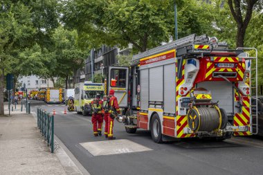 Gennevilliers, Fransa - 07: 14: 2025: Paris itfaiyecileri ve itfaiyecilerinden oluşan bir kırmızı itfaiye aracı acil bir itfaiyeyi söndürmek için müdahale etti