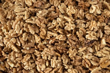 Pile of walnut kernels, top view. A closeup. Brain food, organic nuts, eating healthy fat concept.