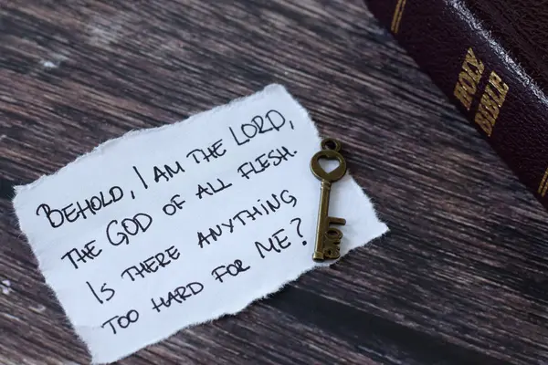 Handwritten Christian verse about the power and love of God with ancient key and holy bible book on wood. Christian biblical concept.