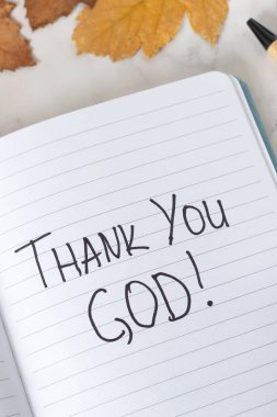 Teşekkürler Tanrım, deftere sonbahar yapraklarıyla birlikte el yazısıyla yazılmış bir mesaj. Yakın plan. İncil 'deki şükran, şükran ve şükran kavramını İsa' ya borçluyuz..