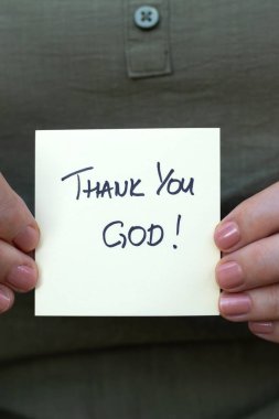 Hristiyan bir kadın, elinde elle yazılmış bir not tutuyor: Yakın plan. İncil 'deki şükran ve şükran kavramı İsa' ya..