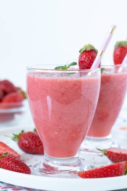 Taze naneli çilekli smoothie ve beyaz arka planlı bir bardakta chia tohumu. Uzayı kopyala Yakın plan. Sağlıklı yaz detoks içeceği.