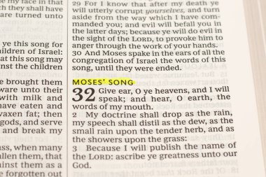 Moses' song text in open holy bible book. Christian praise, salvation, and worship of God Jesus Christ. Biblical concept. Close-up.