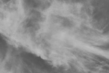 Gray sky and white clouds. Beautiful sky background. Black and white photo.