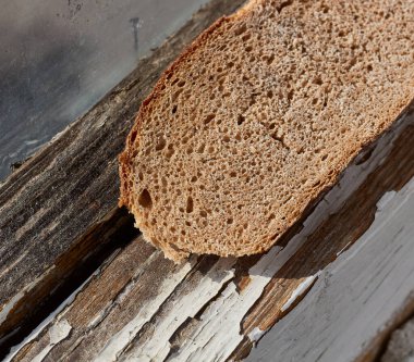 A piece of dry bread on the windowsill.