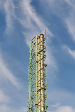 Industrial pipe with a metal frame on the background of the sky.