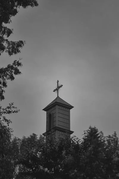Catholic dome with a cross. Black and white photo.