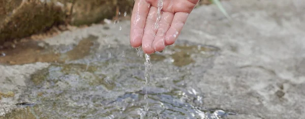 Hand and drops of water. Pour water on your hand.