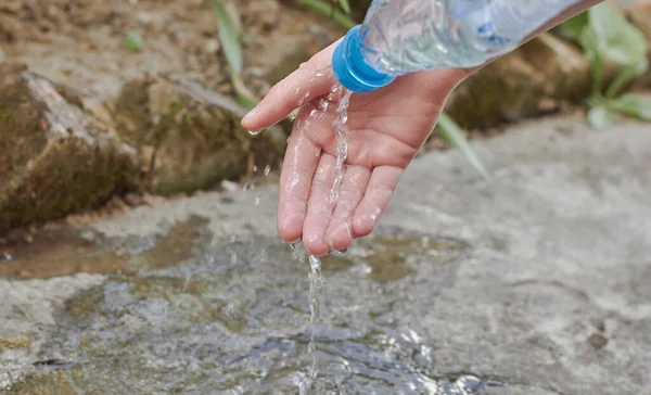 Hand and drops of water. Pour water on your hand.