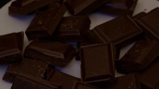 Rotation Von Stücken Dunkler Schokolade Auf Einem Tablett Von Oben — Stockvideo