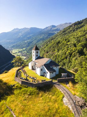 Aerial view of San Martino Church in Calonico during summer day, Leventina, Switzerland.  clipart