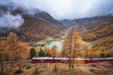 Alp Grum Gölü, Graubunden ile Rhaetian Demiryolu 'ndan kırmızı trenin manzarası. İsviçre.