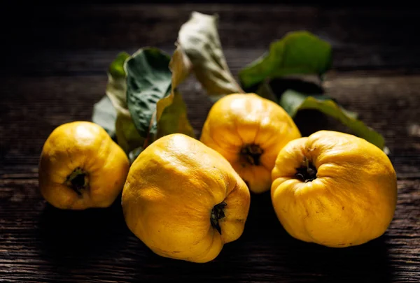 stock image Ripe quince on a wooden table, close up view