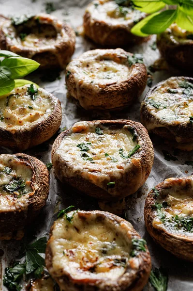 Baked mushrooms stuffed with cheese and herbs, focus on the mushroom  inside, close-up