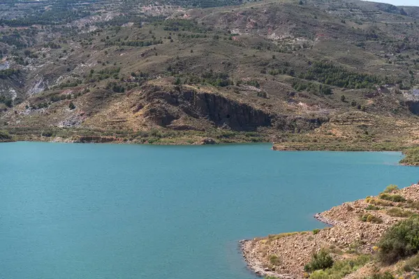 stock image Beninar Reservoir in the south of Andalusia, it is a mountain area with bushes and trees