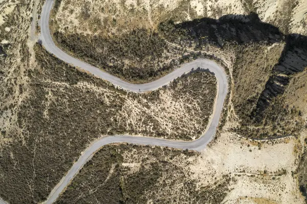 stock image overhead photo of a road in the south of Granada, there are bushes, there are ravines