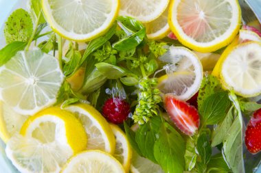 Fresh infused water made with organic citruses ,basil ,strawberries and blueberries clipart