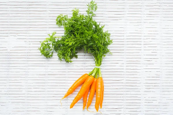 freshly harvested bunch of carrots on a white background