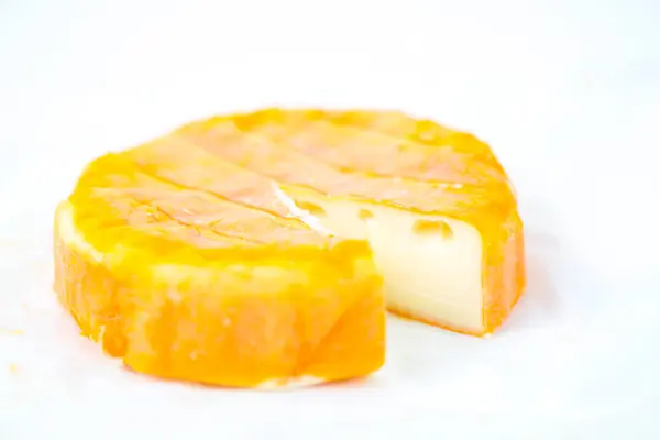 Soft yellow cheese with mold