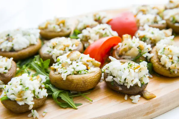 Mushrooms (champignons) stuffed with vegetables, rice and cheese, close up, horizontal