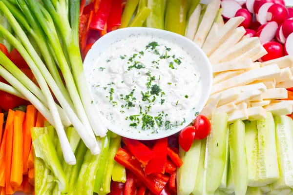 fresh Greek Tzatziki yogurt dip (sauce) and assorted vegetables on napkin