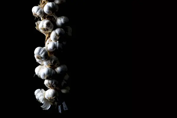 Garlic bundle on the black isolated background
