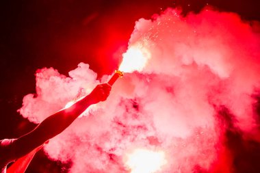 futbol taraftarları bir maç sırasında yangında meşaleler tutan