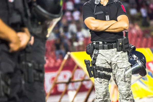 A cop with a weapon on stadium