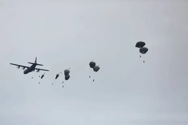 stock image lots of parachutists in the cloudy sky 