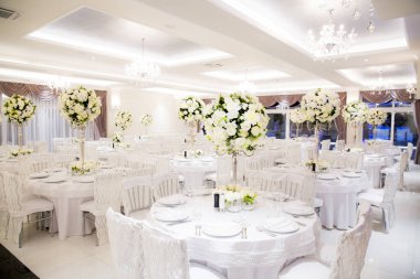 Beyaz renklerle süslenmiş güzel bir düğün salonu.