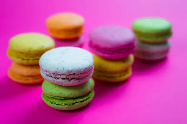 sweet macaroons on pink background