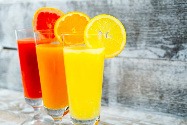 freshly squeezed juices on wooden background